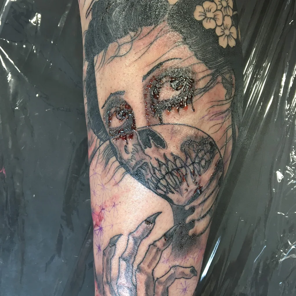 Geisha with skull mask forearm tattoo, fresh ink