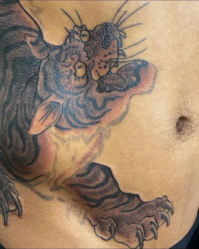 Traditional Japanese tiger tattoo across the stomach